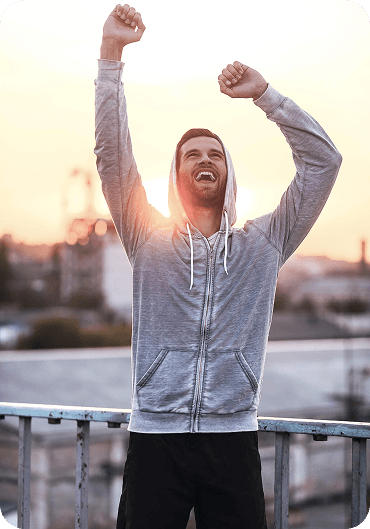 Happy man celebrating with raised fists, symbolizing improved communication and emotional connection after couples therapy