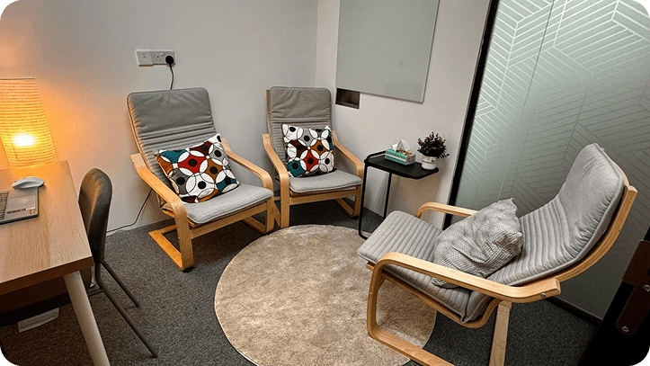 Cozy and private counseling room with comfortable chairs and soft lighting, designed for safe and confidential therapy sessions